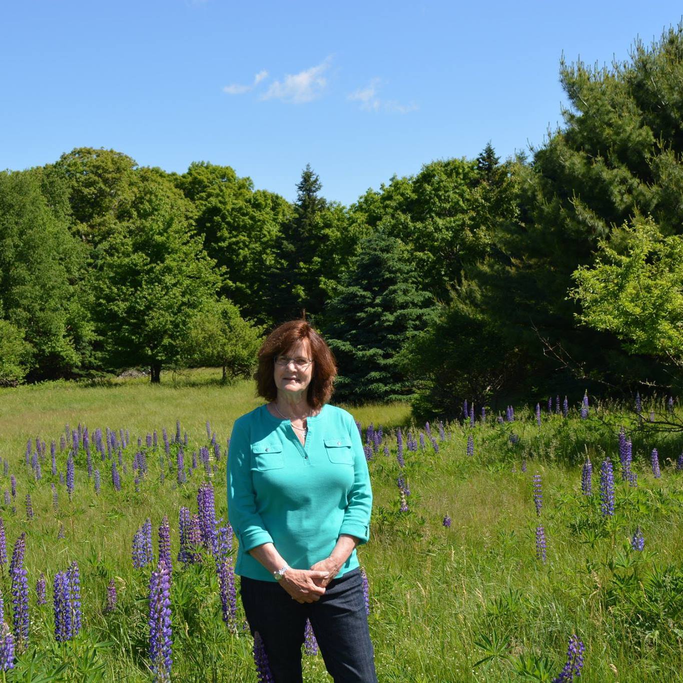 Nana standing in a meadow filled with flowers